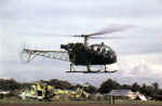 A HAL Cheetah, from the Army Aviation Corps, makes a low pass over Vavuniya Airstrip. A Mi-25 Hind gunship, seen in the background, lies parked. - http://www.bharat-rakshak.com/LAND-FORCES/Army/Images-1987.html